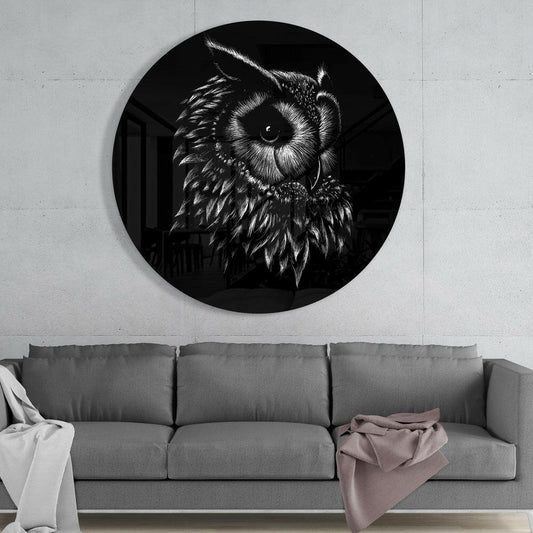 Circular black glass wall art with detailed white owl sketch mounted above gray sofa in modern interior.