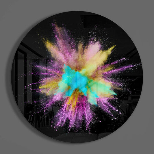 Circular black glass wall art featuring a radial powder burst in cyan, yellow, purple, and pink colors against a dark background.