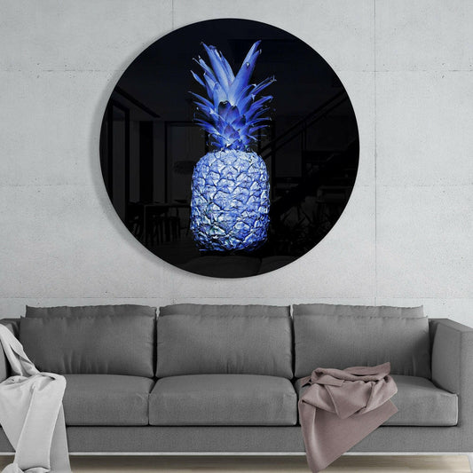 Electric blue glass pineapple wall art mounted in black circular frame above gray sofa in modern interior.