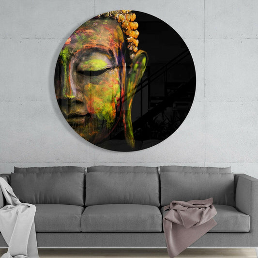 Circular glass wall art featuring a colorful Buddha head with vibrant yellow, green, and red tones, displayed above a gray sofa in a modern interior.