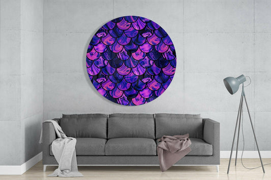 Circular purple and pink mermaid scale glass wall art hanging above gray sofa in minimalist living room interior.