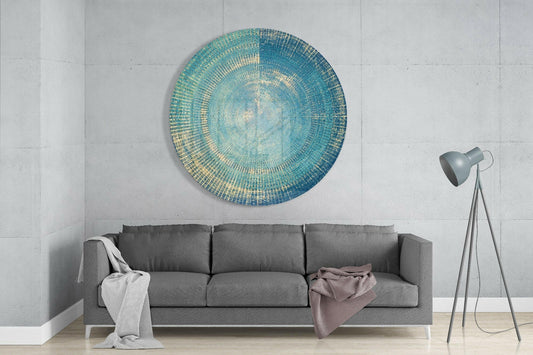 Teal woven concentric rings glass wall art hanging above gray sofa in minimalist living room interior.