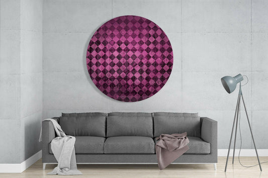 Pink and burgundy diamond checker pattern glass wall art hanging above gray sofa in modern living room.