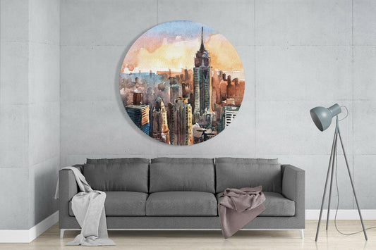 Round watercolor New York City skyline artwork with Empire State Building displayed above gray sofa in modern living room.