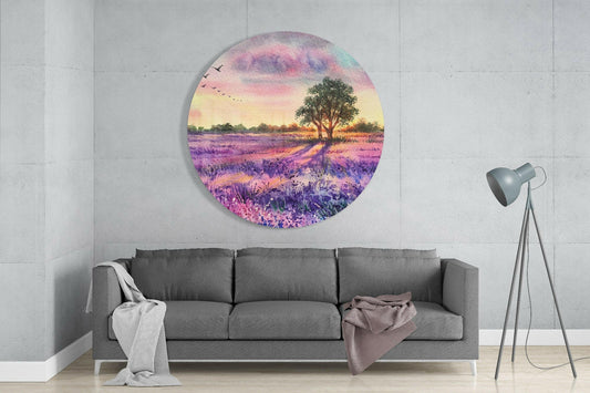 Circular glass wall art depicting a purple lavender field with a solitary tree at sunset, installed above a gray sofa in a modern living room.