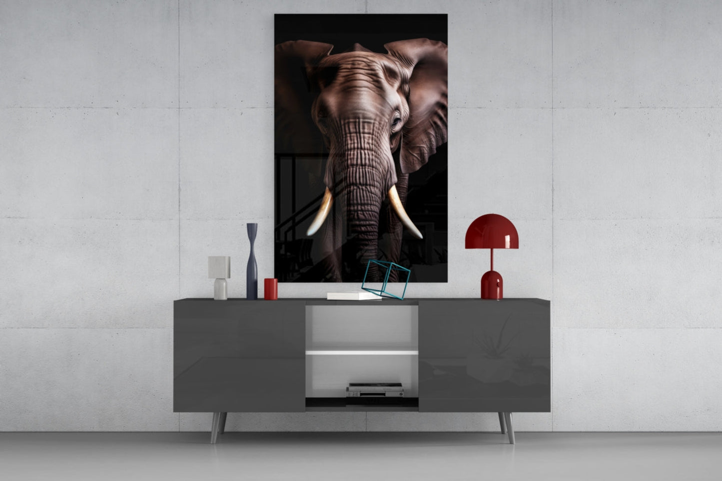 Elephant glass wall art displayed above gray media console with red lamp and decorative accessories in modern interior setting.