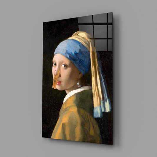 Glass wall art depicting a young woman in profile wearing a blue headwrap and golden earring against a dark background.
