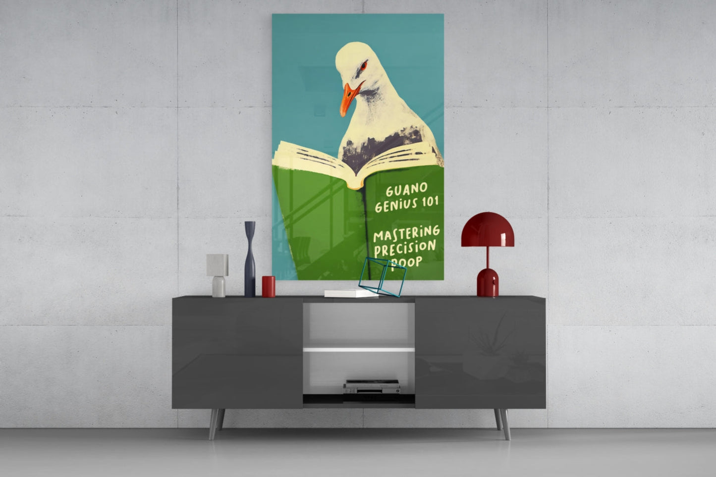 Seagull reading green book titled "Guano Genius 101" displayed above dark sideboard against white wall.