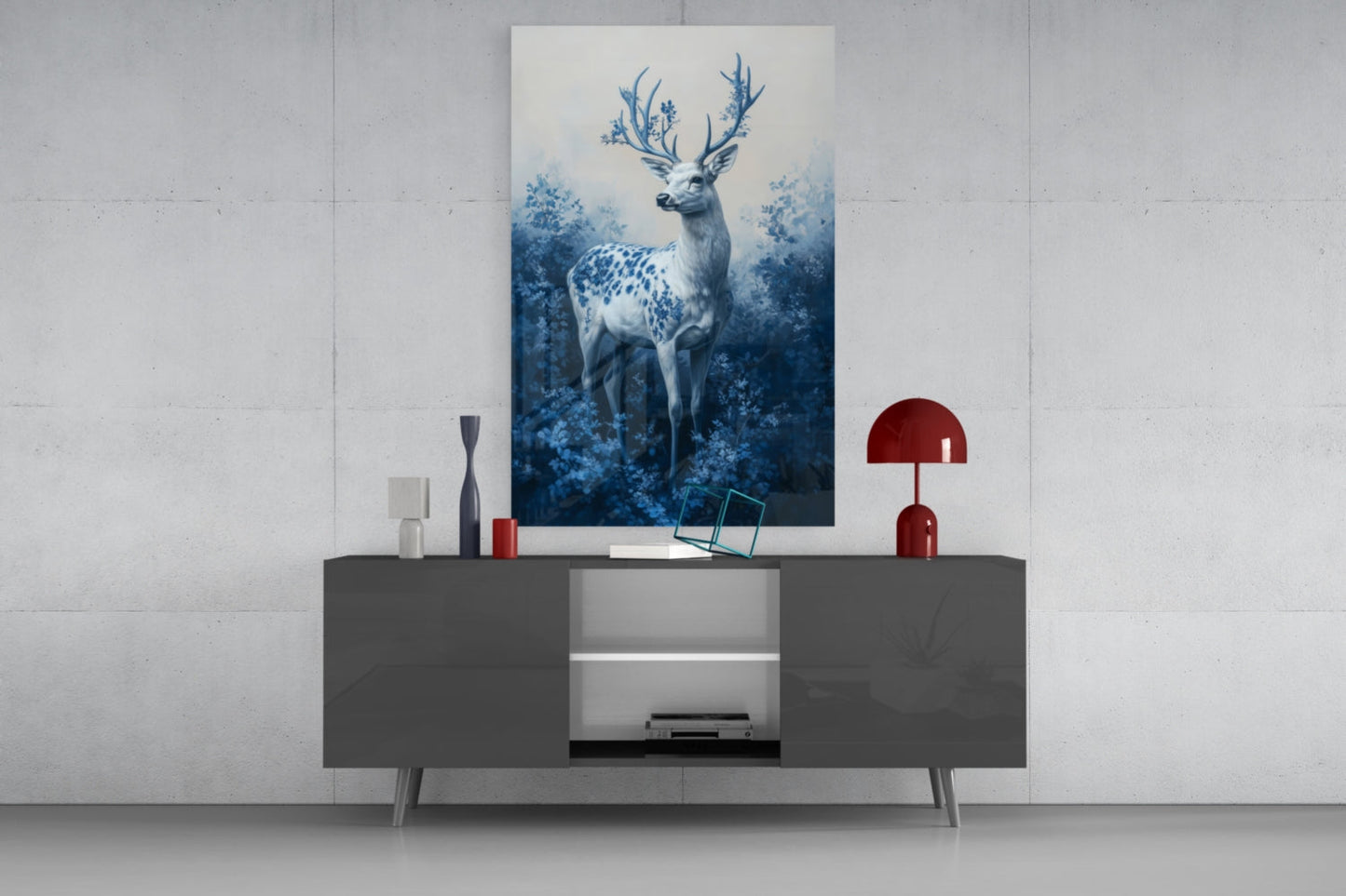 Blue and white deer with flowering antlers displayed on light gray wall above dark console table with red lamp and accessories.