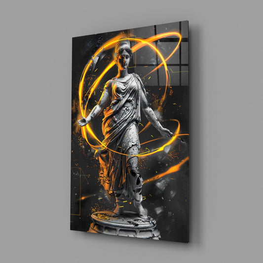 Angled side view of glass wall art depicting a classical stone statue surrounded by glowing amber neon orbital lines on black background.