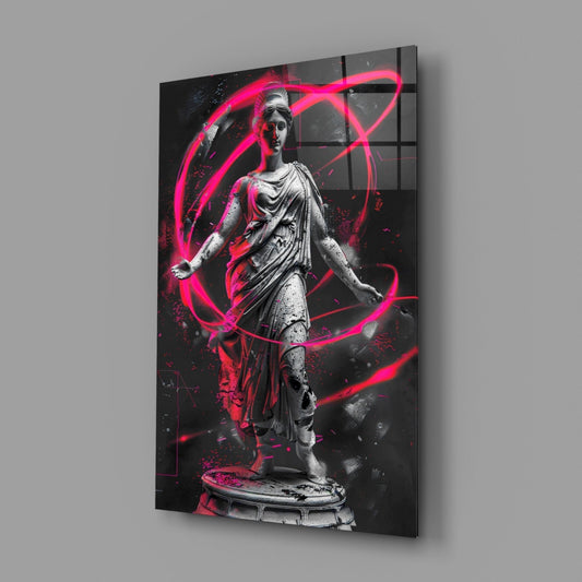 Angled view of glass wall art featuring a grayscale classical statue surrounded by bright pink neon line designs against a dark background.