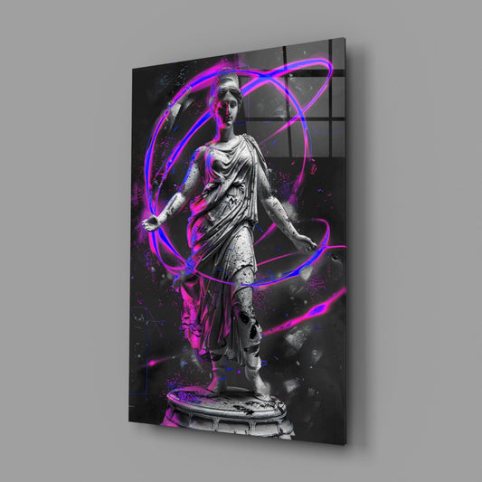 Angled view of glass wall art depicting a classical stone statue surrounded by vibrant magenta and blue neon light trails against a dark background.