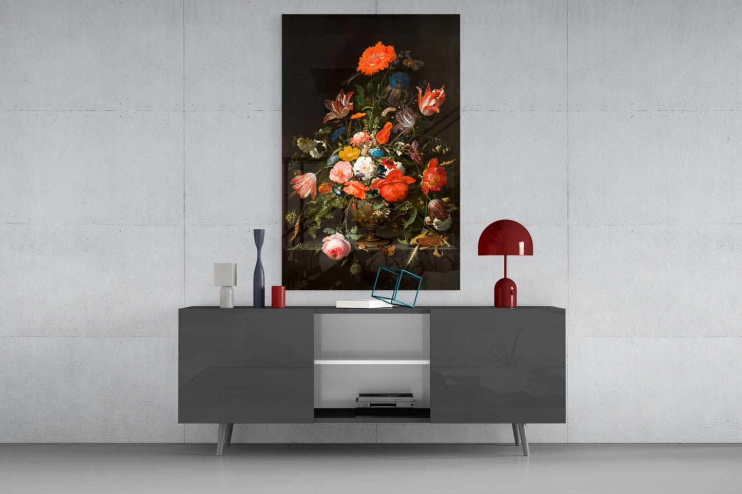 Dark floral still-life glass wall art displayed above a gray media console with red accents and decorative objects.