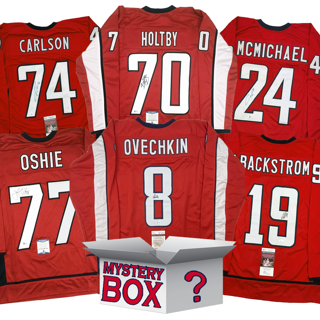 Five signed red hockey jerseys arranged around a white mystery box with question mark, displaying player names Carlson, Holtby, McMichael, Oshie, and Ovechkin with visible authentication labels.