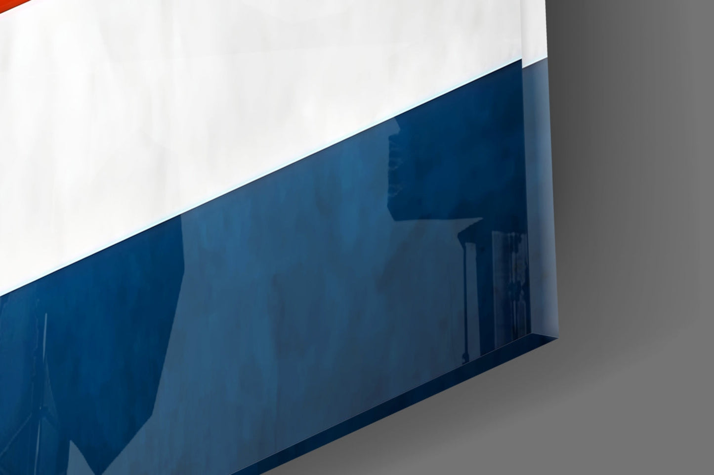 Close-up angled view of blue and white glass wall art with Costa Rican flag colors and reflective surface.