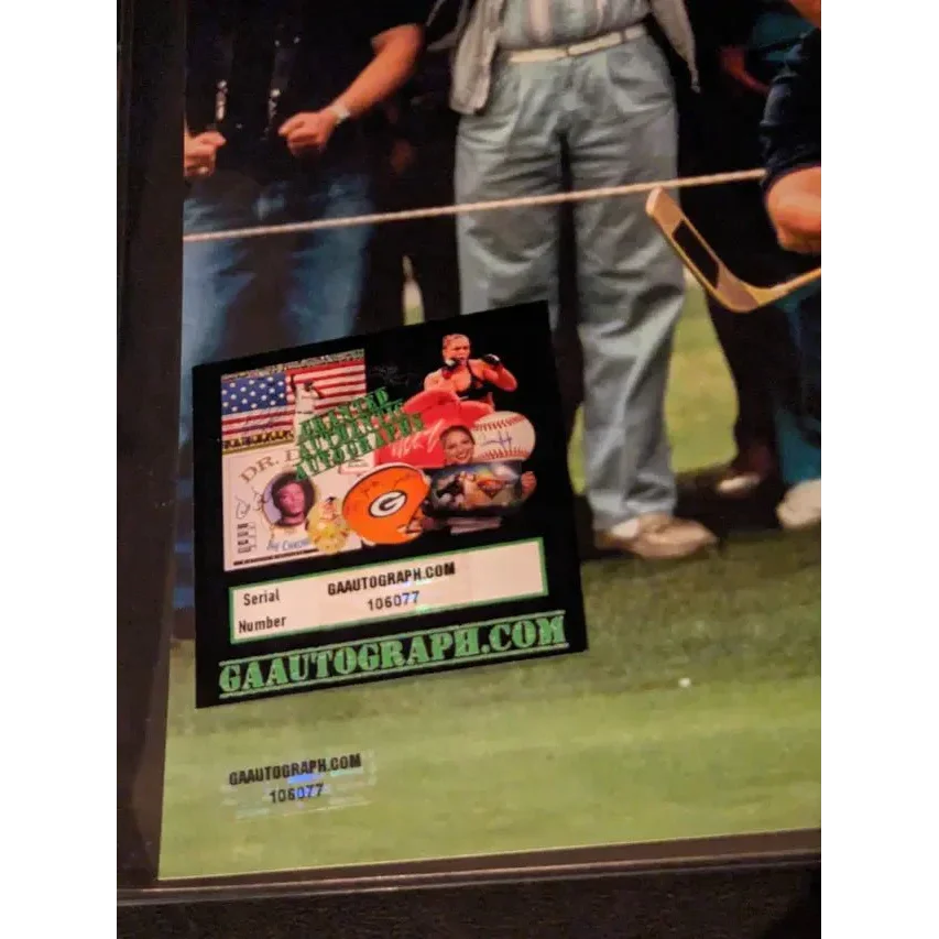 Autographed memorabilia certification sticker on Adam Sandler autographed 8x10 golf photo