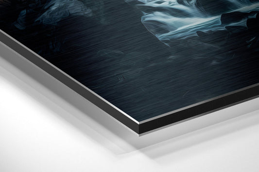 Close-up angled view of layered aluminum composite print edge showing dark brushed surface with white backing material and gray border trim.