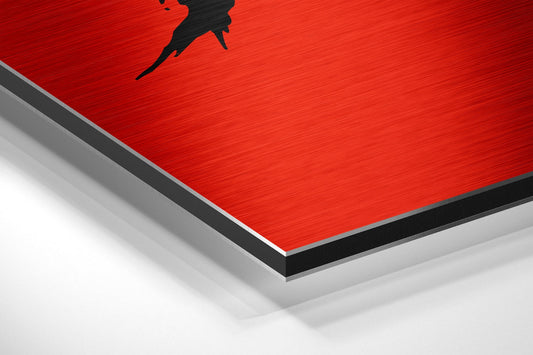 Close-up angled view of red brushed aluminum Dibond panel with black silhouette figure and layered edge detail against white background.