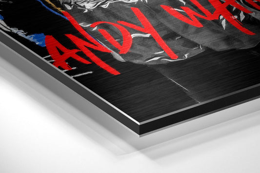 Close-up angled view of brushed aluminum dibond wall art featuring red graffiti text and boxing figures on black background.