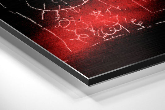Angled perspective view of brushed aluminum dibond wall art featuring red and black surface with white chalk graffiti markings.