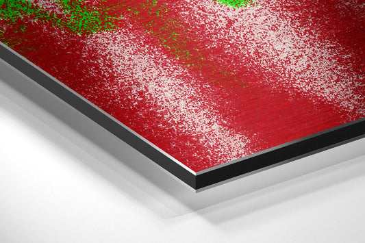 Close-up angled view of layered red, black, and white dibond panel with textured surface and green spray paint details.