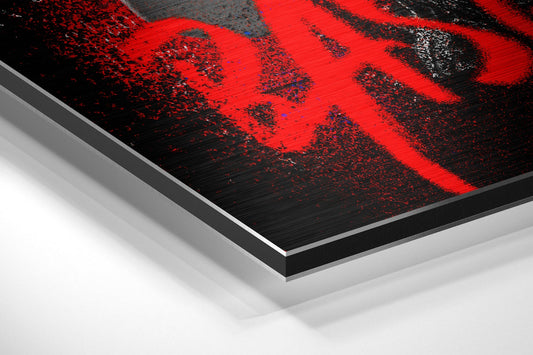 Close-up angled view of layered aluminum dibond panel showing red and black brushed metal surface with edge detail.