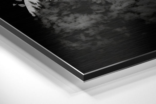 Close-up angled view of layered Dibond panel edges showing brushed black aluminum surface with white backing material.