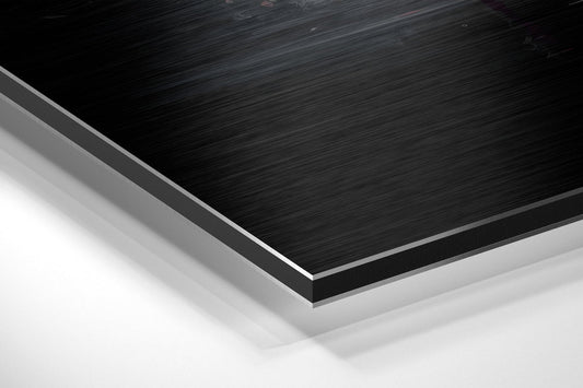 Angled close-up of layered brushed aluminum and white composite materials showing edge detail and surface texture.