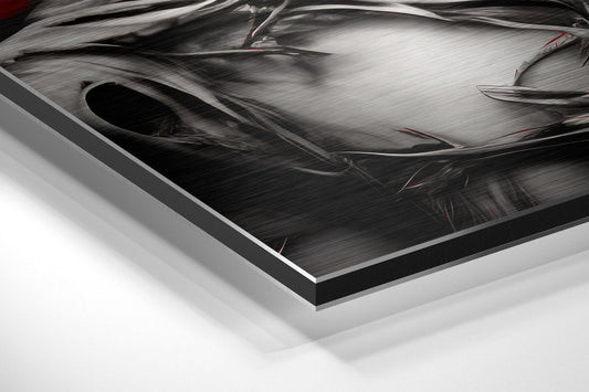 Close-up angled view of brushed aluminum Dibond art panel showing metallic surface texture with black border edge and white background.