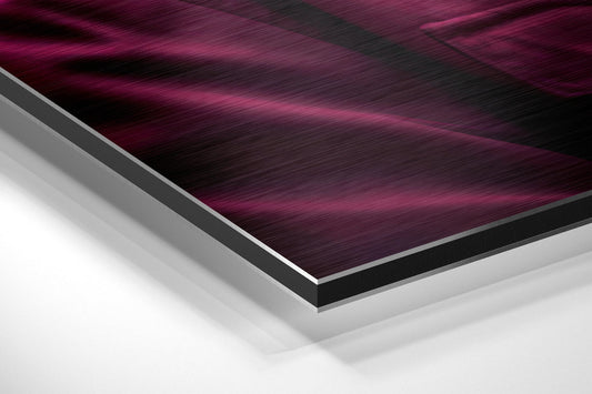 Close-up angled view of layered materials showing brushed aluminum edge, black border, and white backing of dibond wall art.