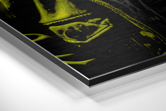 Close-up angled view of layered aluminum dibond print showing yellow gorilla DJ artwork on black brushed surface with white backing visible.