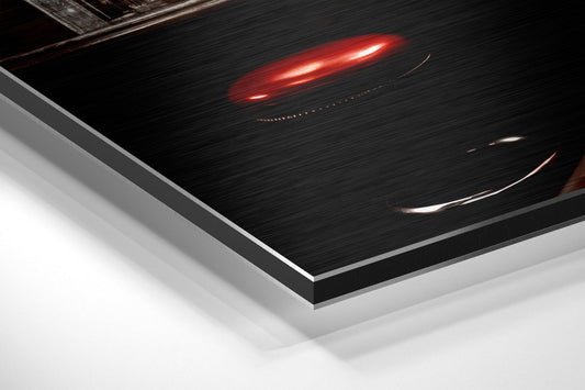 Close-up angled view of brushed aluminum Dibond panel edge showing layered construction with black brushed surface and silver aluminum trim.