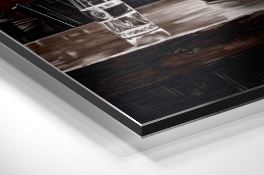 Close-up angled view showing layered construction of brushed aluminum dibond print with dark wood grain image and white backing material.