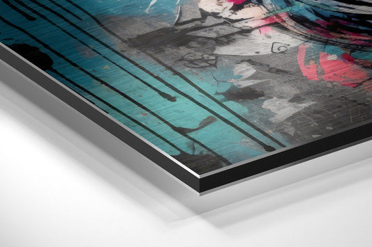 Close-up angled view of brushed aluminum dibond wall art layers showing turquoise, gray, white, and pink graffiti design with visible edge construction.