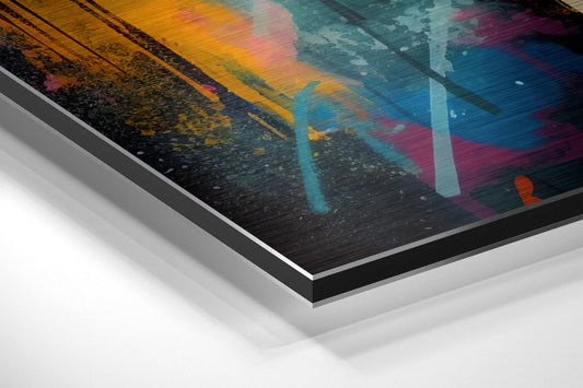 Angled perspective view of layered aluminum dibond print showing colorful abstract brushstrokes in yellow, teal, pink, and black on textured surface.