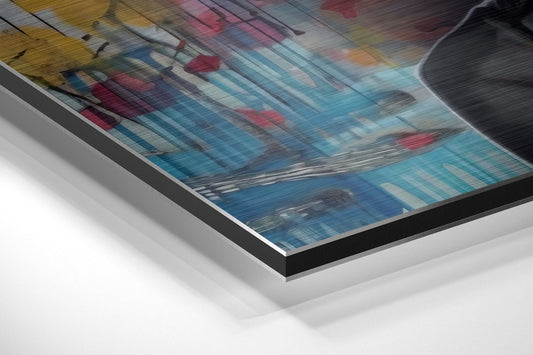 Angled perspective view of brushed aluminum Dibond wall art displaying colorful abstract floral design with blue, pink, and yellow tones.