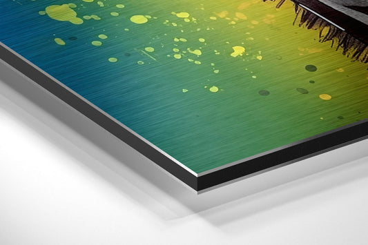 Close-up angled view of brushed aluminum Dibond wall art with blue-to-yellow gradient and circular details.