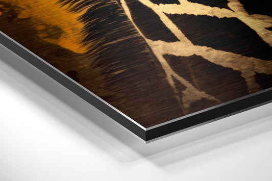 Close-up angled view of layered aluminum dibond print edges showing brown giraffe pattern with cream spots and black background.