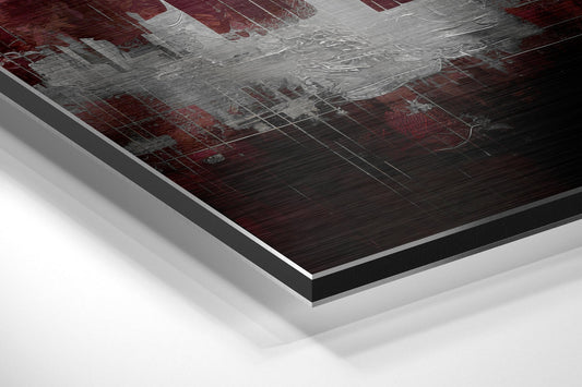 Angled perspective shot of Crimson Sky City Skyline aluminum dibond print showing layered edge detail and brushed metal surface finish.