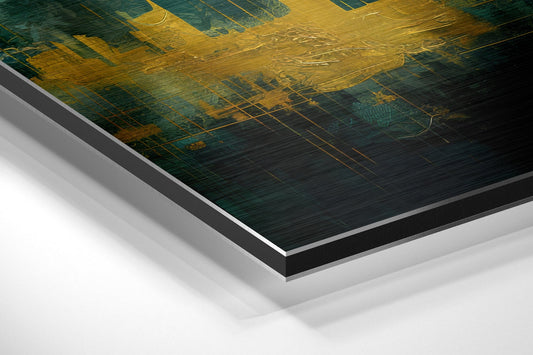 Angled perspective of layered aluminum dibond print showing golden and dark teal abstract cityscape with brushed metallic finish and white backing.
