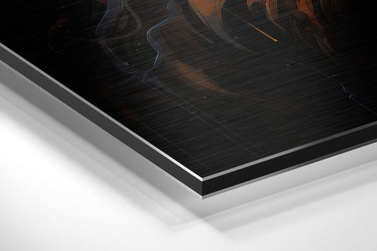 Close-up angled view of layered aluminum dibond panel showing black brushed surface with orange and blue curved streaks, white backing layers visible.