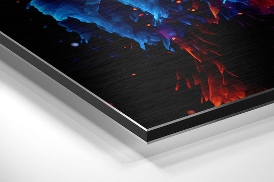 Angled view of layered aluminum dibond panel displaying vibrant blue and red powder burst design on black brushed surface.