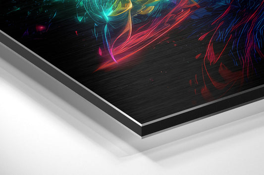 Angled perspective view of brushed aluminum Dibond wall art displaying vibrant neon red, cyan, and yellow ribbon-like light streaks on black textured background.