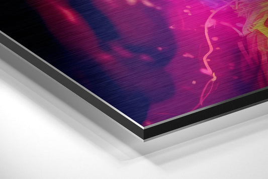 Angled perspective view of brushed aluminum Dibond wall art showing glowing neon profile of astronaut helmet in magenta, pink, and yellow against dark background.