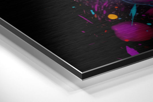 Angled view of brushed aluminum dibond panel displaying colorful paint splashes in magenta, cyan, yellow, and red on black textured surface.