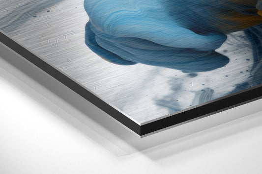 Angled perspective view of brushed aluminum Dibond panel with blue and white abstract brushstroke design and black edge trim.