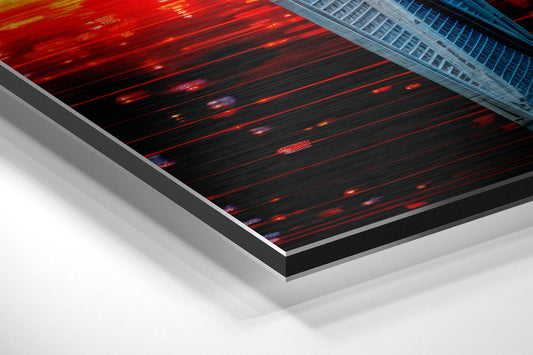 Angled perspective view of brushed aluminum dibond wall art with red glitch stripes and blue accents on black background.