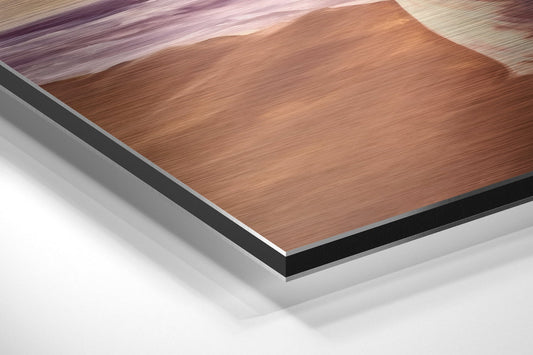Close-up of layered material composition showing brushed copper-toned surface, black edge trim, and white base layer in angled perspective view.