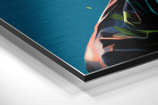 Close-up angled view of brushed aluminum dibond print showing vibrant pop art woman's face with lime green earrings against teal blue background.
