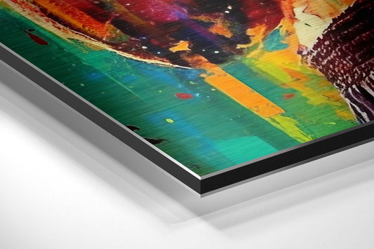 Angled perspective view of layered aluminum dibond art print showing vibrant rainbow and dark abstract imagery on glossy surface with beveled edge detail.